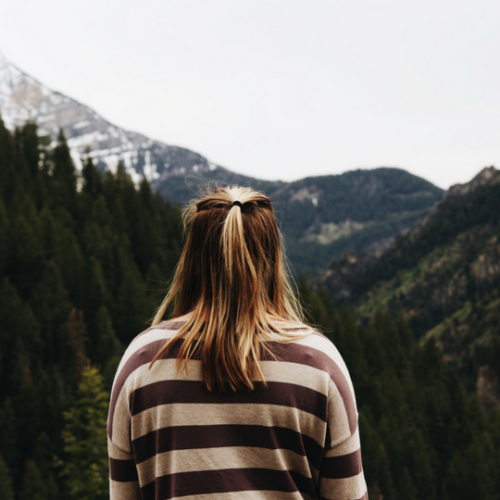Girl standing in front of a mountain