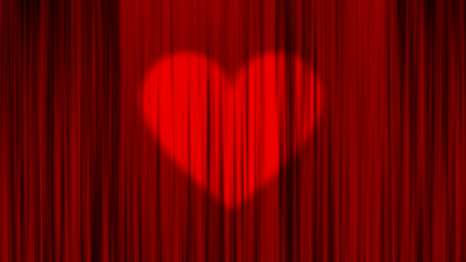red curtain with a heart made out of spotlights