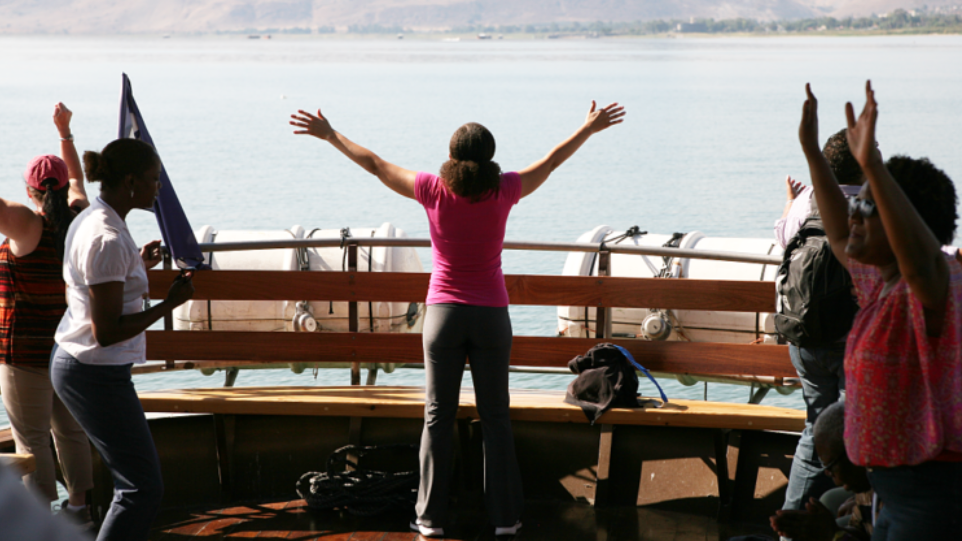 Woman worshipping on the Sea of Galilee